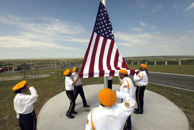 Members of American Legion Post 269 in Wanblee raise the flag during the dedication of the Akicita Owicahe Lakota Freedom Veterans Cemetery.